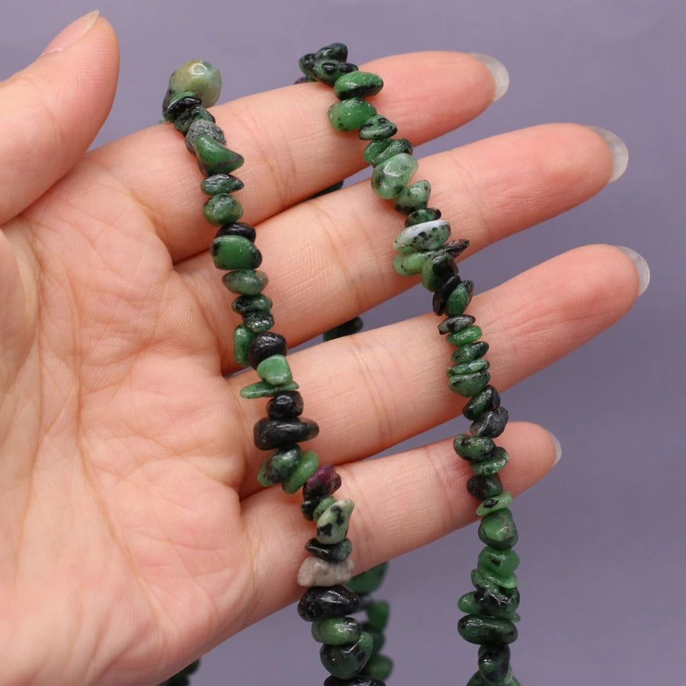 Person Holding Emerald Beads Necklace