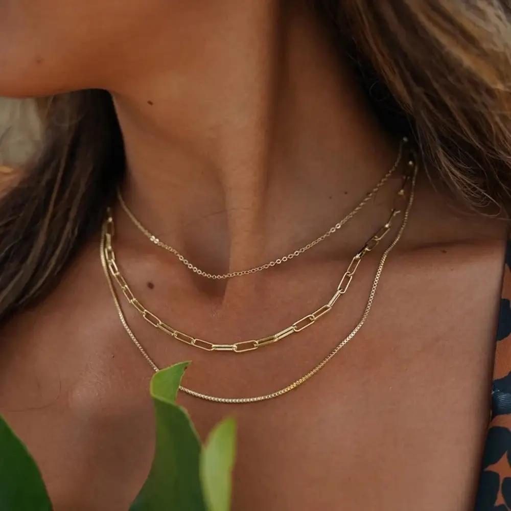 Brunette woman wearing Gold Layered Necklaces