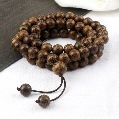 Mens Wooden Bead Necklace rolled up on a white background