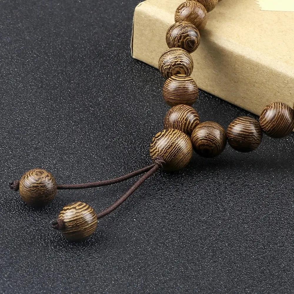 Close up of the beads from Mens Wooden Bead Necklace on a dark gray background